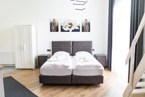 a bedroom with a bed with two white pillows at KMS Homes - air conditioning - near Legoland Günzburg in Bubesheim