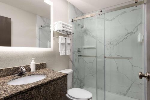 a bathroom with a shower and a sink and a toilet at Days Inn by Wyndham Williams in Williams