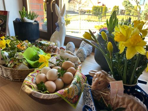 a table topped with baskets of eggs and flowers at Chata za wsią - Czorsztyn Lake, Kluszkowce Ski in Kluszkowce