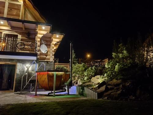 a large bowl sitting outside of a building at night at Chata za wsią - Czorsztyn Lake, Kluszkowce Ski in Kluszkowce