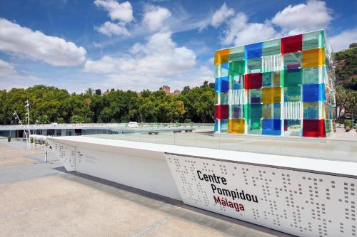 a multicolored building with a sign in front of it at Ikos Andalusia in Estepona