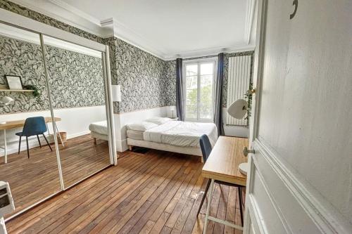a bedroom with a bed and a desk and a window at Flexliving - room - Daumesnil in Paris