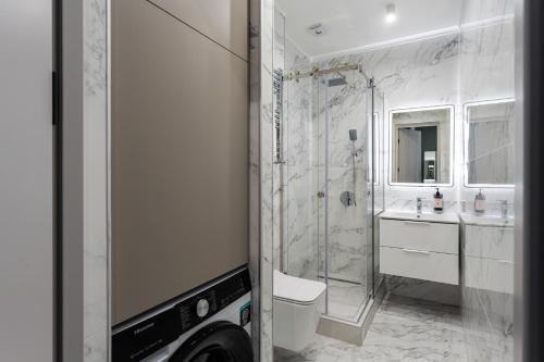 a bathroom with a shower and a toilet and a sink at Apartment KeyGo #0096 comfort and coziness in the city in Yerevan