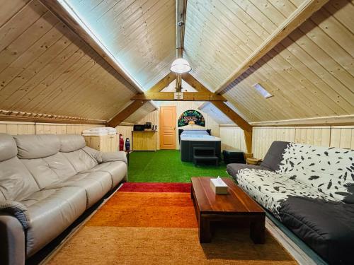a living room with a couch and a table at Espace Piscine et SPA Villa des Cortins in Dierrey-Saint-Julien