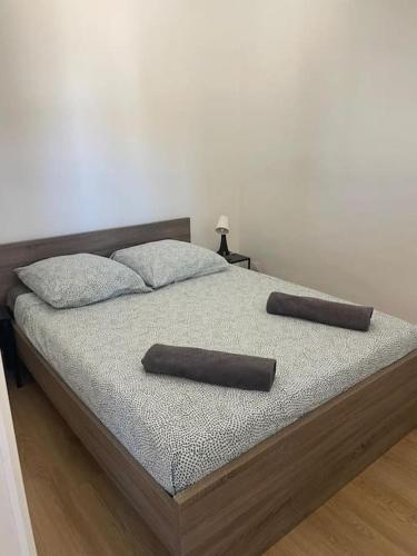 un lit avec deux oreillers dessus dans l'établissement Le Pardigon -Fibre-Climatisation, à Marseille
