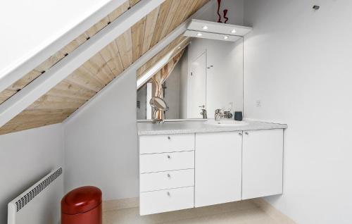 a white bathroom with a sink in a attic at Lovely Home In Fur With Sauna in Fur