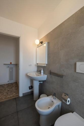 a bathroom with a sink and a toilet and a mirror at Top Living Apartments - Carducci in Turin