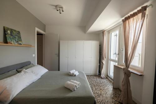 a bedroom with a bed with two towels on it at Top Living Apartments - Carducci in Turin