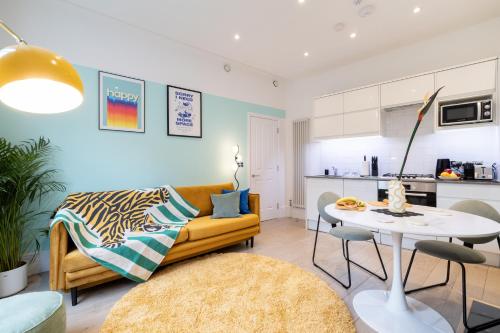a living room with a couch and a table at Stay Kula London - Covent Garden Opera House in London