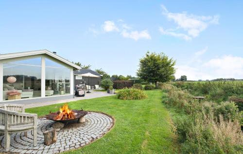 a fire pit in a yard next to a house at 4 Bedroom Nice Home In Gilleleje in Gilleleje