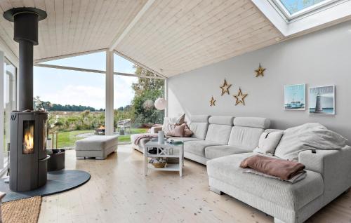 a living room with a couch and a fireplace at 4 Bedroom Nice Home In Gilleleje in Gilleleje