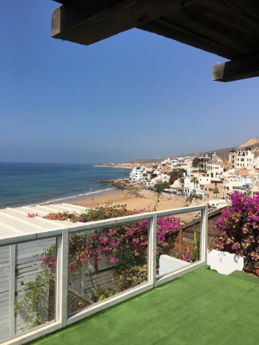 a view of the beach from the balcony of a house at Nizar Surf Morocco in Taghazout