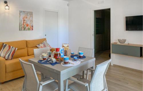 ein Wohnzimmer mit einem Tisch mit Stühlen und einer Couch in der Unterkunft Cozy Apartment In Marina Di Modica in Marina di Modica