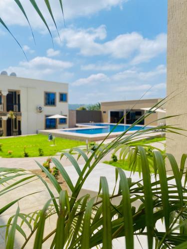 a view of a house with a swimming pool at AIDEN HOMES AND APARTMENTS HOTEl in Koforidua