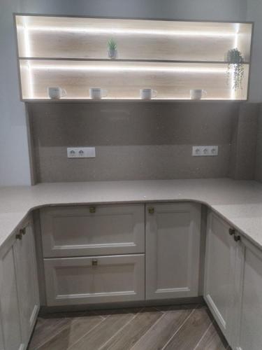 a kitchen with white cabinets and a counter top at Villa haut standing avec piscine chauffée sans vis-à-vis et hammam in Ouled Moussa