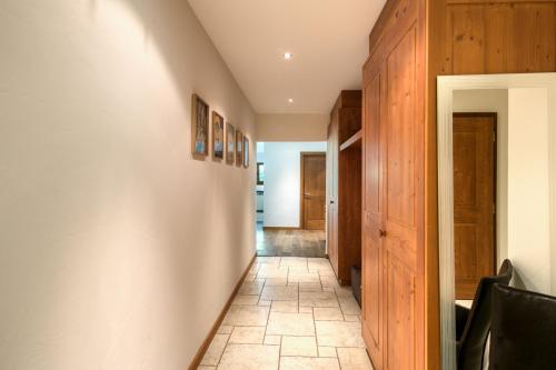 a hallway of a house with wooden walls at Lodge 1, Hot Tub And Bbq in Champéry