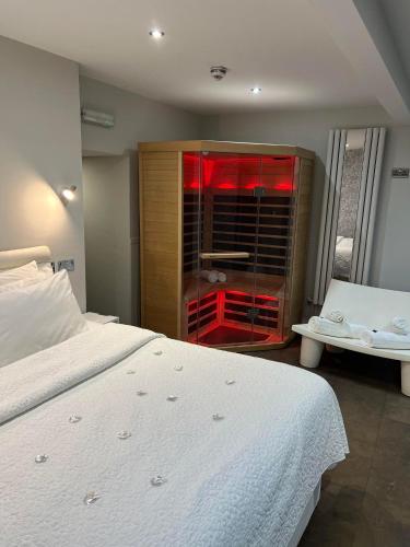 a bedroom with a white bed and a glass cabinet at Thomas Wright House in Byers Green