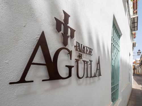 a sign on the side of a building at Bhost - Palacete del Águila in Córdoba