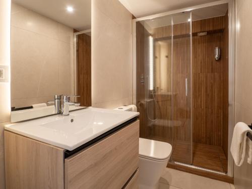 a bathroom with a sink and a shower and a toilet at Bhost - Palacete del Águila in Córdoba