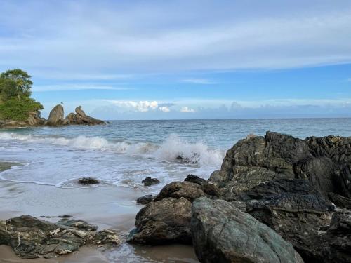 a group of rocks on the shore of the ocean at Saman - Paradise With A View - Vista Mare in Santa Bárbara de Samaná