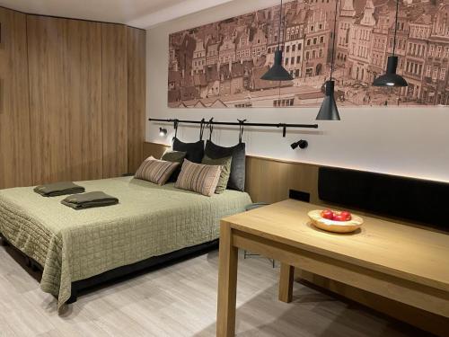 Ένα ή περισσότερα κρεβάτια σε δωμάτιο στο Apartament Officyna