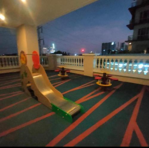 a playground with a slide on a balcony at night at Unit 3J Signature Suites, Lafayette Megaworld in Iloilo City