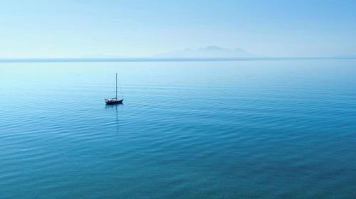 a boat in the middle of a large body of water at Ikos Aria in Kefalos