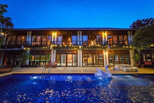 a large house with a swimming pool in front of it at SS pool villa hills in Ban Tao Than
