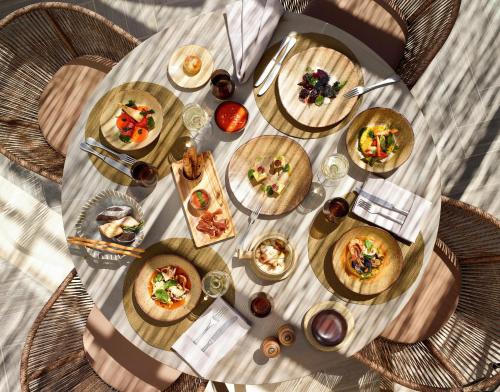 a table with many plates of food on it at Ikos Aria in Kefalos
