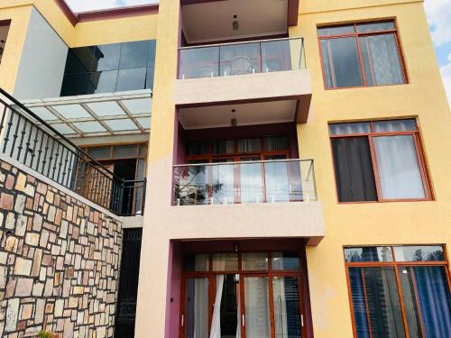 an apartment building with balconies and windows at ROBERT Villa APARTMENT in Kigali
