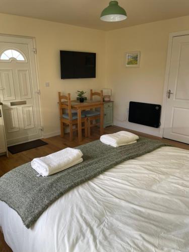 ein Schlafzimmer mit einem großen Bett mit zwei Kissen darauf in der Unterkunft McCaffertys in Drumahayre