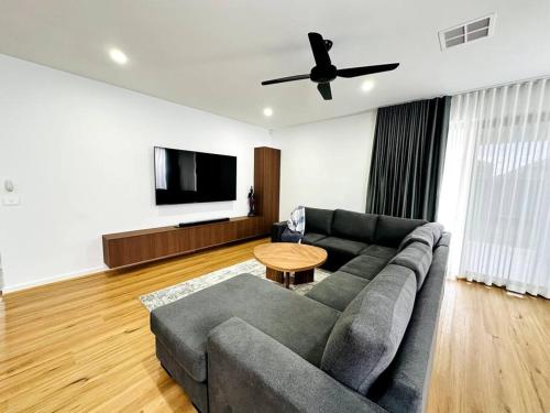 a living room with a couch and a table at Family retreat-Spacious 4BR in Donnybrook