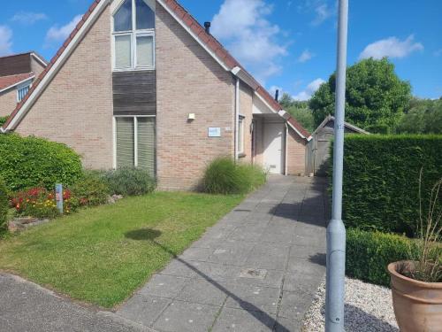 a house with a pole in front of it at Hello Zeeland - Vakantiehuis Zwin 174 in Breskens