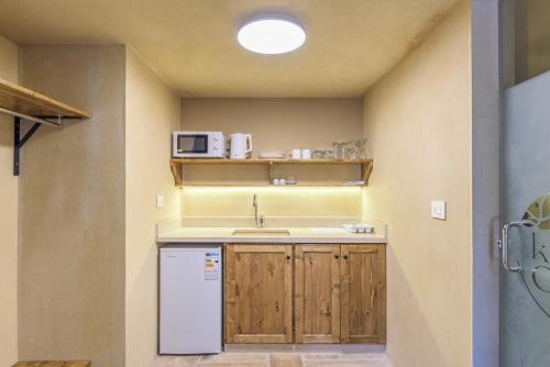 a small kitchen with a sink and a microwave at Casa Batroun Lofts in Batroûn
