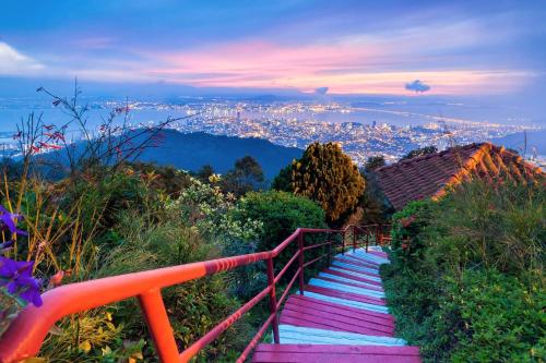a set of stairs with a view of a city at Kek Lok Si Inn in Ayer Itam