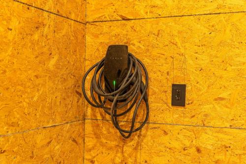 an electronic device with a coil of cord on the floor at Artisan Oasis-hot Tub Fire Pit 8bd Whole House in Indianapolis