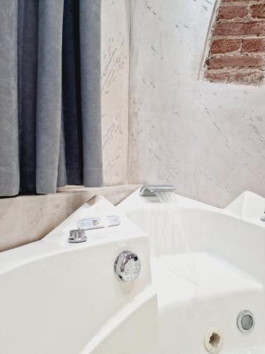 a bathroom with a white sink next to a tub at Residence Via Duomo in Verona