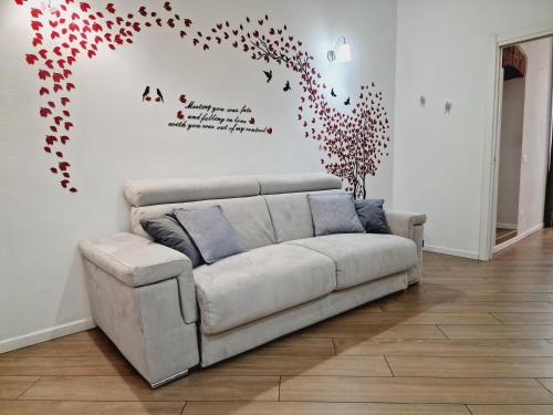 a couch in a living room with hearts on the wall at Residence Via Duomo in Verona