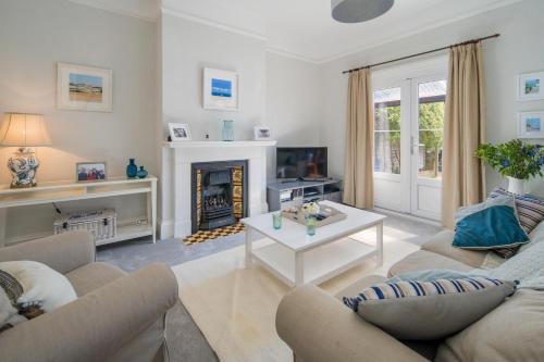 a living room with a couch and a fireplace at Shellharbour in Seaview