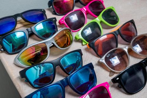 a group of colorful sunglasses sitting on a table at Shellharbour in Seaview