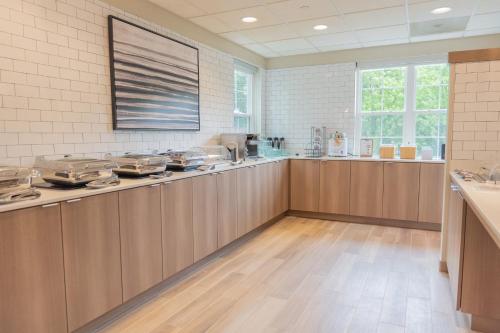 a large kitchen with wooden cabinets and a large window at Residence Inn Asheville Biltmore in Asheville
