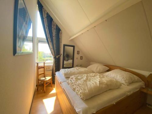 a bedroom with two beds and a window at Hello Zeeland - Vakantiehuis Zwin 092 in Breskens
