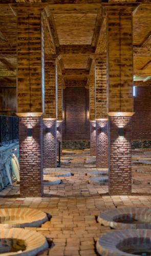 an empty room with brick walls and a wooden ceiling at Burki Castle & Cellar in Kvareli