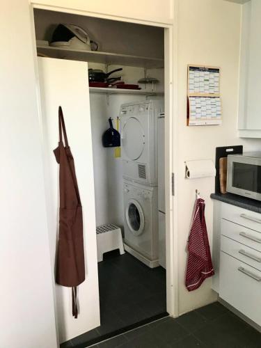 a kitchen with a washer and dryer in a room at Hello Zeeland - Appartement Port Scaldis 19-012 in Breskens