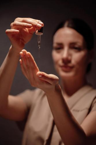 a woman holding a drop of water in her hands at Ikos Olivia in Gerakini