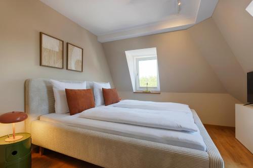 a bedroom with a large bed with a window at Hotel Fischzucht in Würzburg in Würzburg