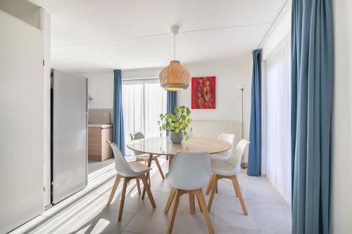 a dining room with a table and chairs at Hello Zeeland - Vakantiehuis Zwin 004 in Breskens