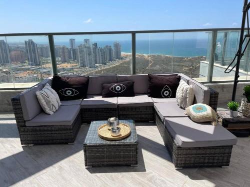 a couch sitting on top of a building at Penthouse Netanya in Udim