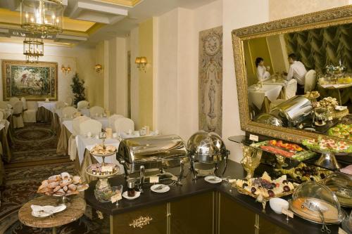 a dining room with a table and a mirror at Imperial Hotel & Restaurant in Vilnius