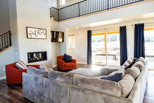 sala de estar con sofá grande y chimenea en Daybreak Mountain Home East Zion & Bryce, en Orderville